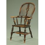 A 19th century broad arm Windsor chair, with pierced splat back, solid seat and turned front legs,