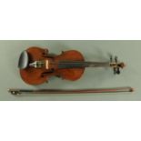 A full size violin, early 20th century, having a figured two piece back, well figured sides,