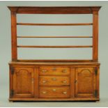 A George III oak dresser with Delft rack,