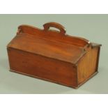 A 19th century candle box, with centre carrying handle and aperture to either side, width 38 cm.