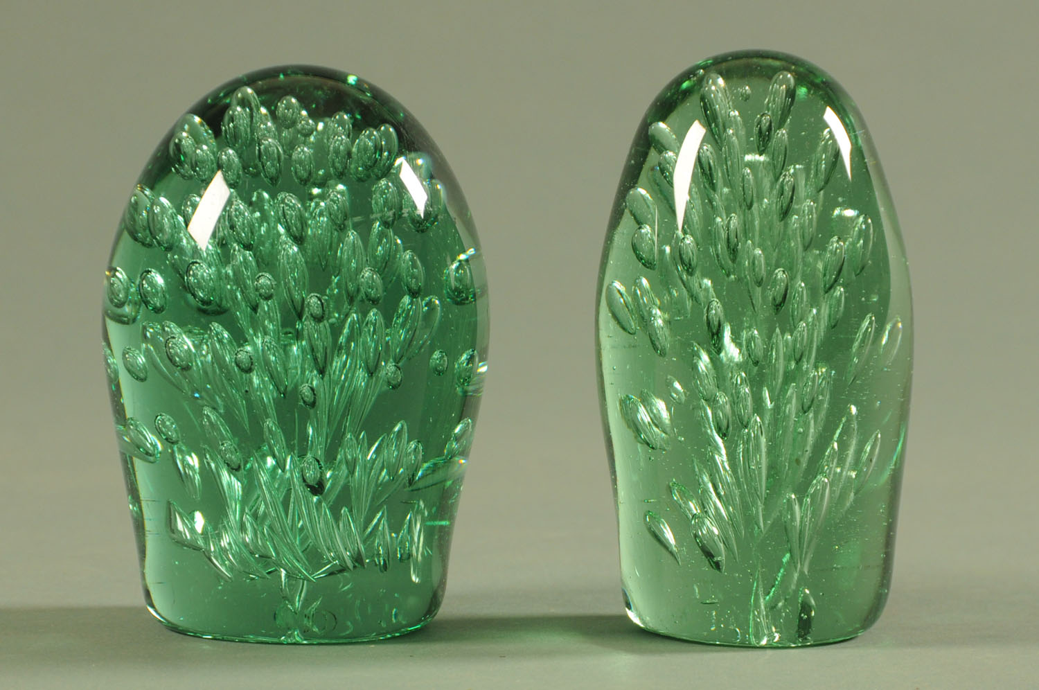 Two Wakefield green glass dumps, 19th century, each with interior air bubble decoration.