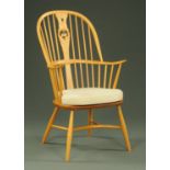 An Ercol Windsor swan back armchair, dated 2000 Anno Domini,