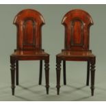 A pair of Victorian mahogany hall chairs, with arched backs,