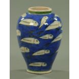 A baluster vase, decorated with sardines, possibly Persian. Height 28 cm.