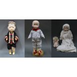 A group of four modern replica dolls,