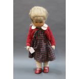 A German Kathe Kruse collector's doll, having red & green knitted cardigan, tartan patterned dress,