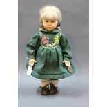 A German Kathe Kruse collector's doll, having green knitted floral patterned dress, muslin body,