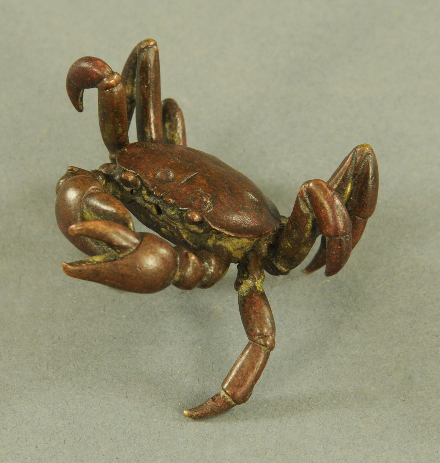 A Japanese bronze model of a crab, Meiji period, signed. Width 6 cm, height 3.5 cm.