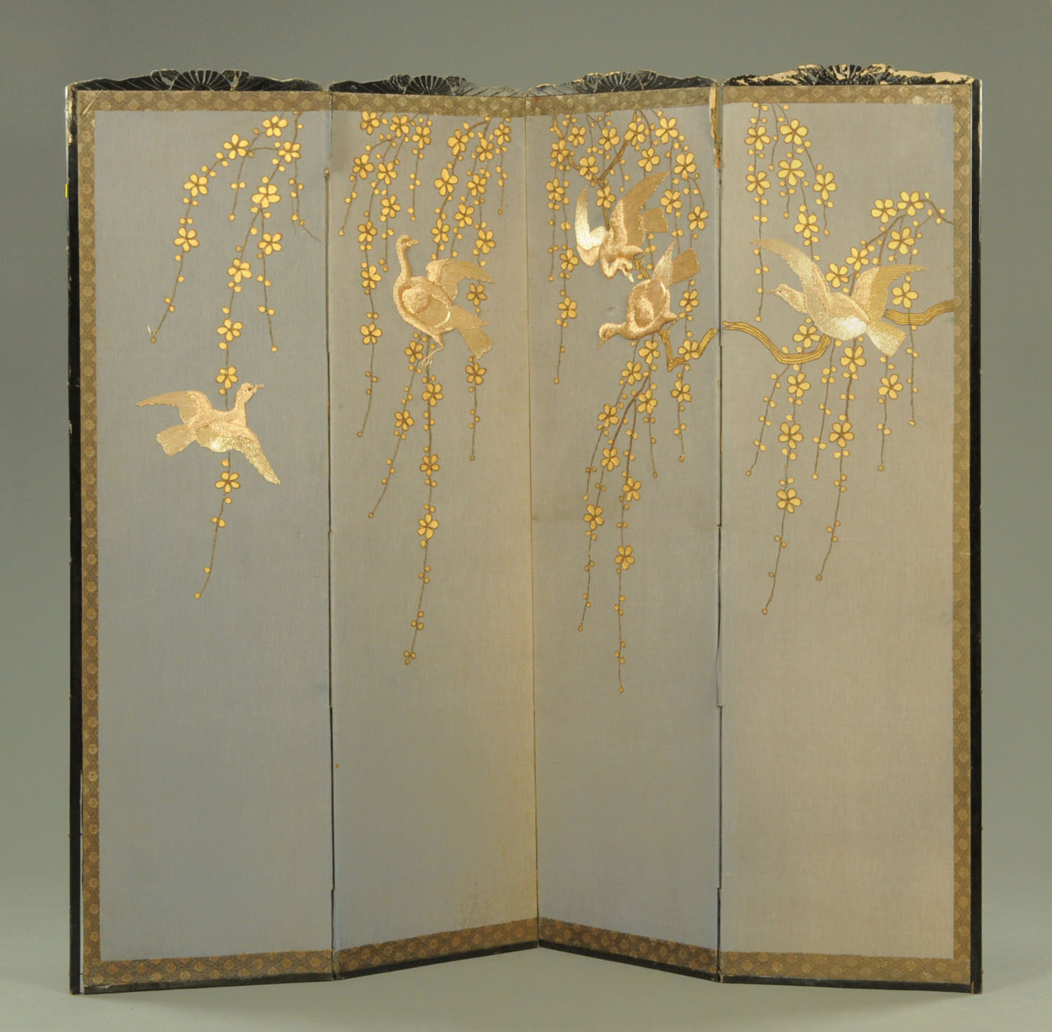 A Japanese embroidered four panel folding screen, circa 1900,