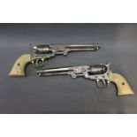 A pair of reproduction single action revolvers, with ivory coloured grips, overall length 33 cm.