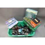 A box containing 5 fixed spool reels, various tackle boxes filled with mepps,