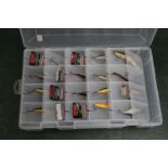 A large plastic box containing 18 Rapala lures.