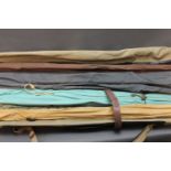 A vintage roll out rod bag containing three rods,