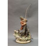 A Capodimonte style figurine, a gentleman with dog and fish. Height excluding fishing rod 30 cm.