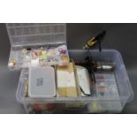 A large plastic box containing a large quantity of fly tying equipment, to include vice, bobbins,