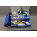 A tackle box filled with lures, pike fishing equipment etc,