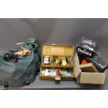 An Abu Garcia fishing bag and a fishing box, filled with Rapalas, flying seeds, 3 fixed spool reels,