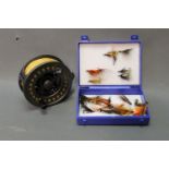 A Daiwa Lochmor 10/11 salmon fly reel, 4 1/8", together with a box of salmon flies.