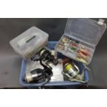 A large plastic tub filled with boxes of plugs, lures, etc., 3 fixed spool reels.