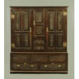 An 18th century and later dark oak cupboard,