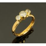 An 18 ct yellow gold three stone diamond ring, with old cut diamonds weighing +/- .