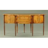 An unusual late Regency mahogany sideboard, having a bowfront back and breakfront,