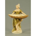 A Royal Dux Art Nouveau figure of a lady, early 20th century, modelled holding a large shell,