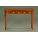 A mahogany side table, fitted with five spice drawers and raised on moulded legs. Width 107 cm.