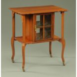 An Edwardian whatnot display, with shaped top, glazed cupboard doors,