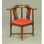 A George III oak corner chair, with outswept arms, splat back,