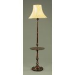 A 20th century carved and turned mahogany standard lamp, with integral silver shaped drinks shelf,