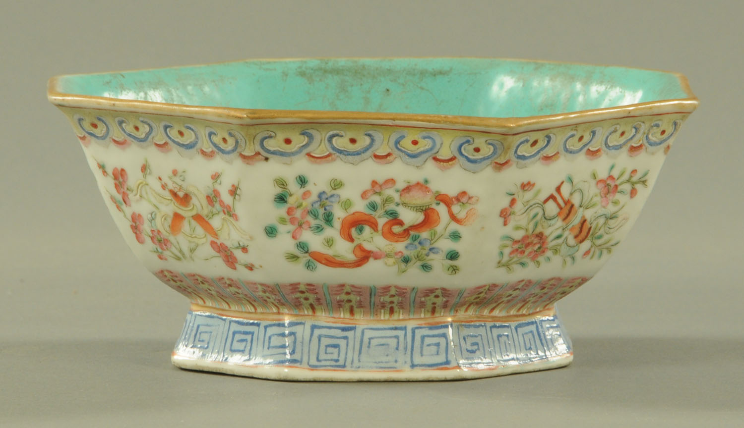 A Chinese famille rose octagonal bowl, 19th century, the interior with blue ground glaze,