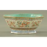 A Chinese famille rose octagonal bowl, 19th century, the interior with blue ground glaze,