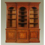 A good Victorian mahogany breakfront triple bookcase on cupboard,