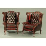 A good pair of oxblood leather button back wing armchairs, 20th century,