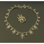 A silver backed marcasite necklace, set with seed pearls and a silver backed marcasite brooch.