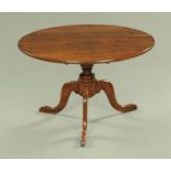 An antique oak tripod table, reduced in height to coffee table size. Diameter 79 cm.