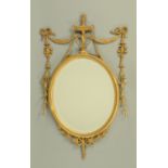 A classical style gilt framed mirror, 19th century, surmounted by an urn with swags, ribbons,