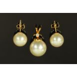 A Chinese pearl pendant, the gold coloured metal suspension set with a small diamond,