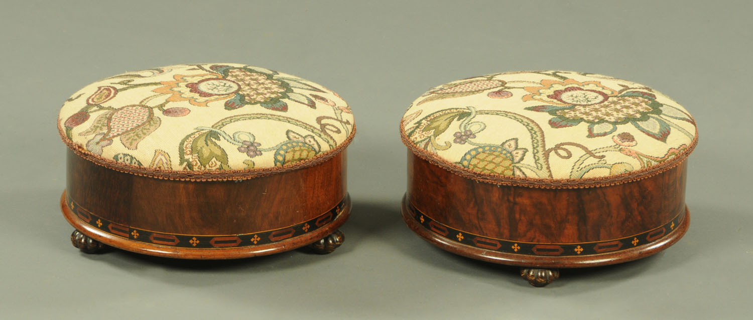 A pair of Victorian walnut veneered footstools, with upholstered hinged tops,