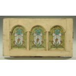 Three arched stained glass and lead panels, held within a white painted casement frame. 92 cm x 50.