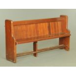 A Victorian pine pew, of typical form, with silhouette ends. Length 170 cm.