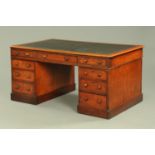 A Victorian mahogany partners desk, with rounded corners and black tooled leather writing surface,
