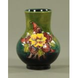 A Moorcroft pansy pattern vase, mid 20th century, with shaded green/blue ground,