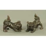 A pair of Oriental style bronzed Shi-Shi dogs,