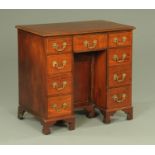 A late 19th century George III style mahogany kneehole desk,