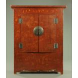 A Chinese lacquered wardrobe, with pair of doors and panelled sides and all raised on stile feet,