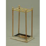 A Victorian brass stick stand, six apertures and with cast iron base. Width 34 cm.