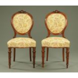A pair of Victorian walnut occasional chairs, with exposed moulded showframes,