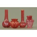 Cranberry glass, comprising two tall neck vases, a squat bulbous vase and a cream jug. Tallest 18.